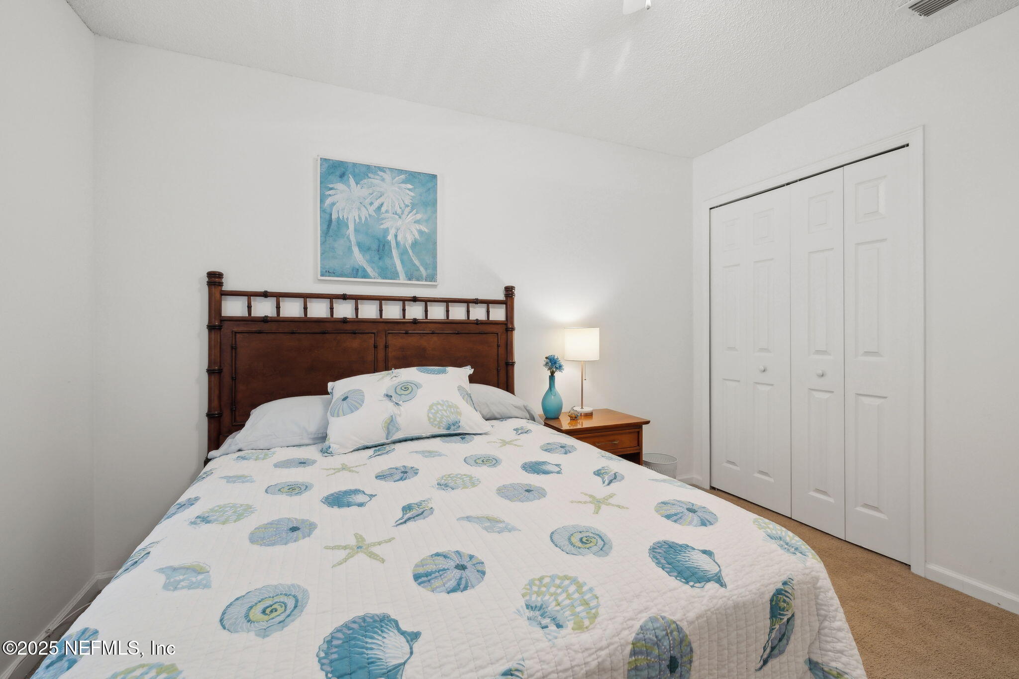 905 Country Bridge Road, Unit 1 St. Johns, FL 32259 - Photo 28 of 43 a bedroom with a large bed and a lamp on dresser