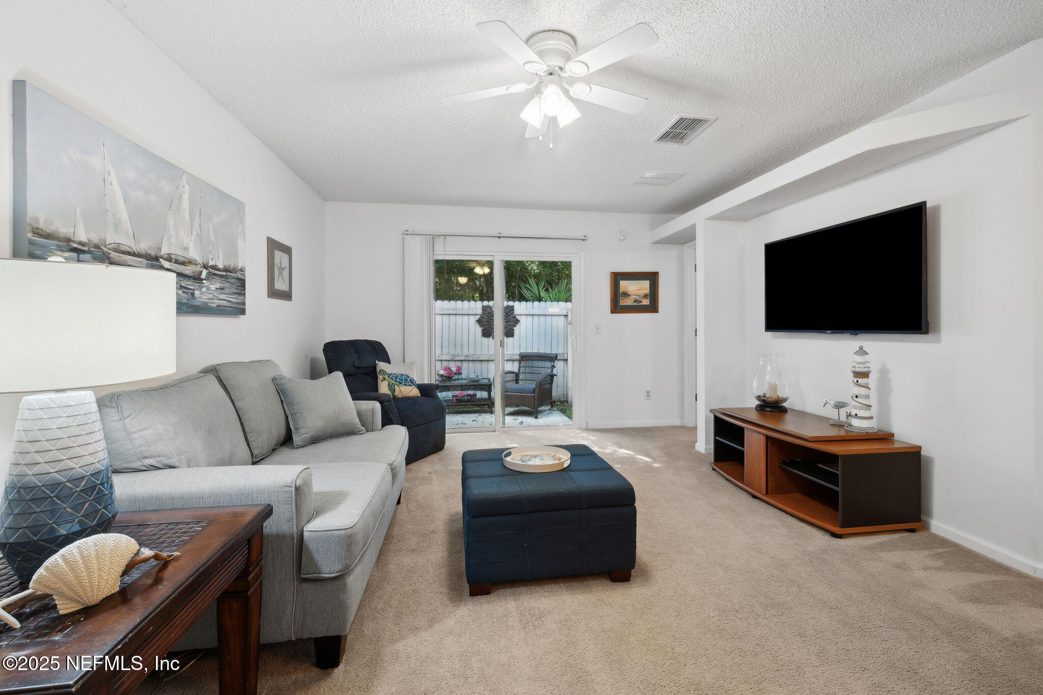 905 Country Bridge Road, Unit 1 St. Johns, FL 32259 - Photo 8 of 43 a living room with furniture and a flat screen tv