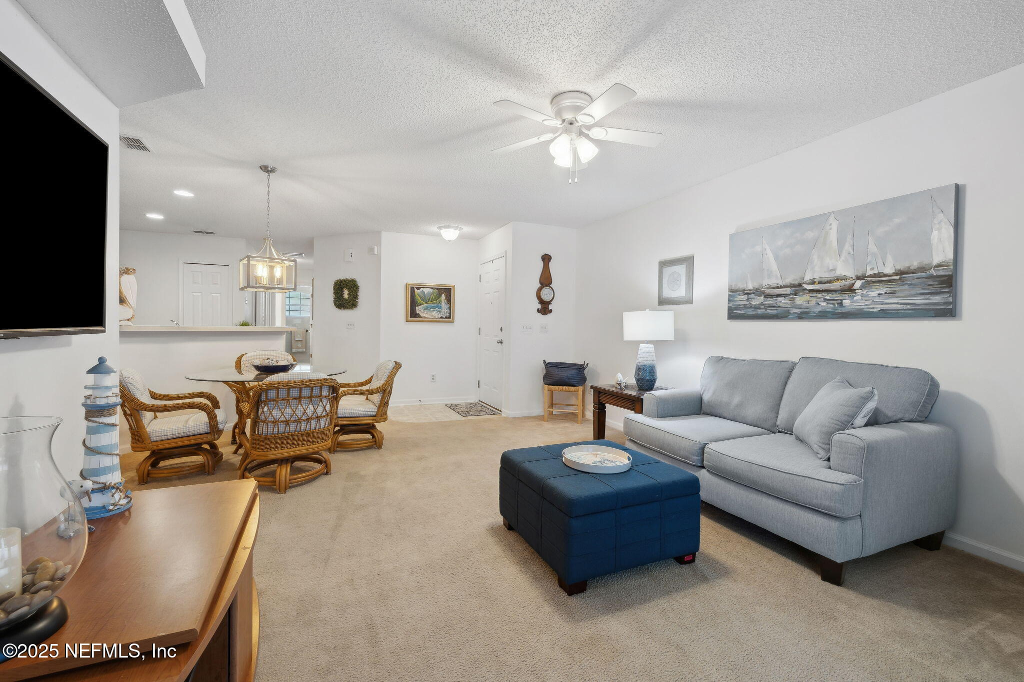 905 Country Bridge Road, Unit 1 St. Johns, FL 32259 - Photo 9 of 43 a living room with furniture and a flat screen tv