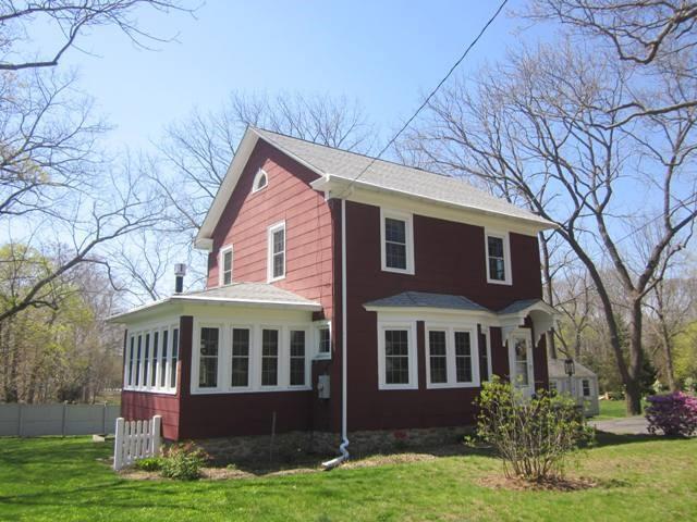 a front view of a house with yard and green space