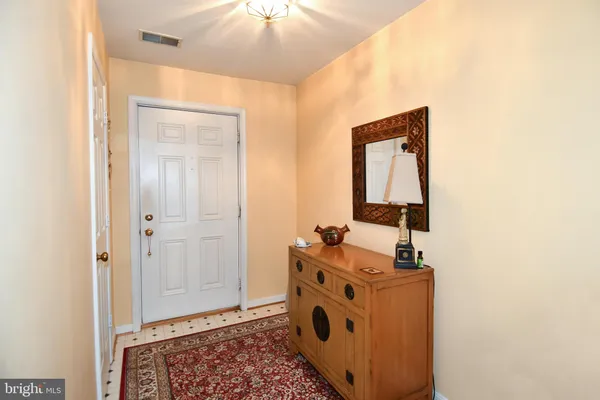 a living room with furniture a bookshelf and a fireplace