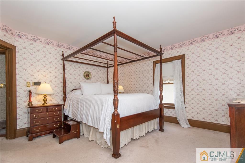 77 Rector Street Metuchen, NJ 08840 - Photo 11 of 24 a bed sitting in a bedroom next to a lamp