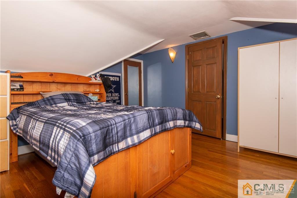 77 Rector Street Metuchen, NJ 08840 - Photo 15 of 24 a bedroom with a bed and a night stand