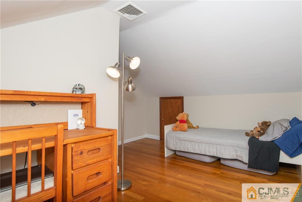 77 Rector Street Metuchen, NJ 08840 - Photo 16 of 24 a bedroom with a bed and cabinets
