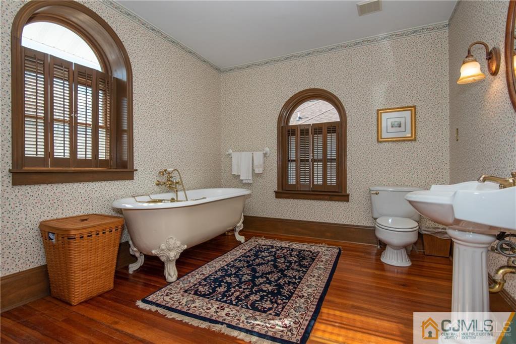 77 Rector Street Metuchen, NJ 08840 - Photo 18 of 24 a bathroom with a bathtub and a window