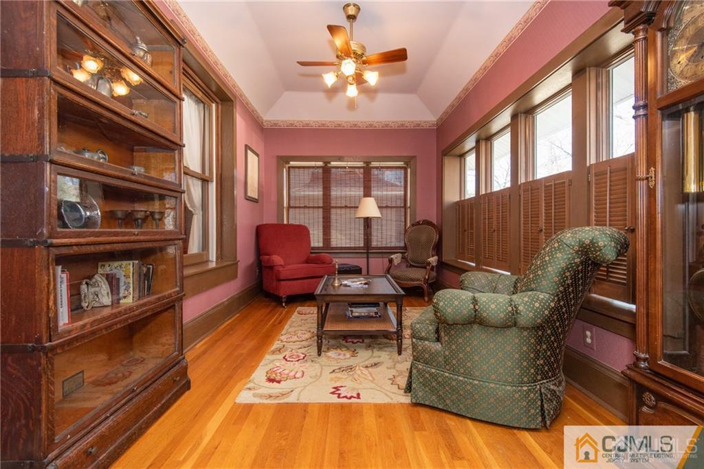 77 Rector Street Metuchen, NJ 08840 - Photo 3 of 24 a living room with furniture a chandelier and a floor to ceiling window