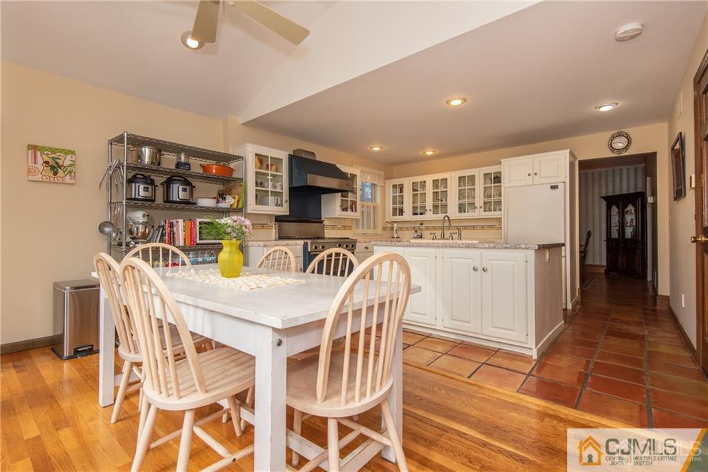 77 Rector Street Metuchen, NJ 08840 - Photo 9 of 24 a kitchen with stainless steel appliances kitchen island granite countertop a refrigerator and microwave