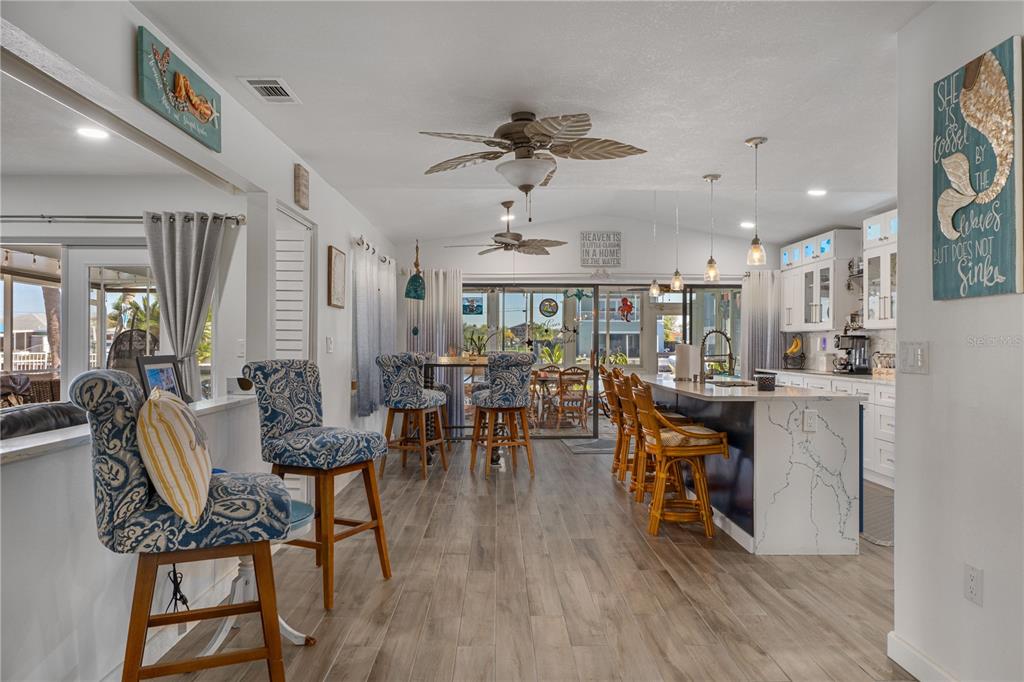 4128 Camelia Drive Hernando Beach, FL 34607 - Photo 12 of 50 a view of a dining room with furniture and wooden floor