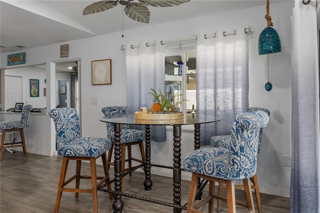 4128 Camelia Drive Hernando Beach, FL 34607 - Photo 17 of 50 a view of a dining room with furniture and wooden floor