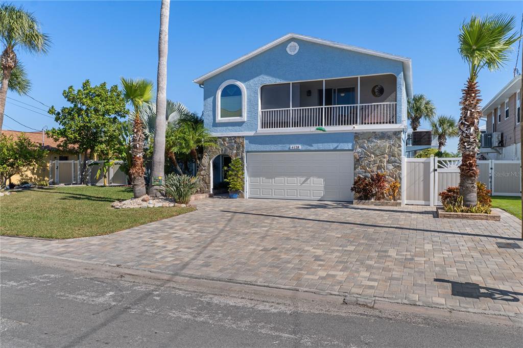 4128 Camelia Drive Hernando Beach, FL 34607 - Photo 2 of 50 a front view of a house with a yard and garage
