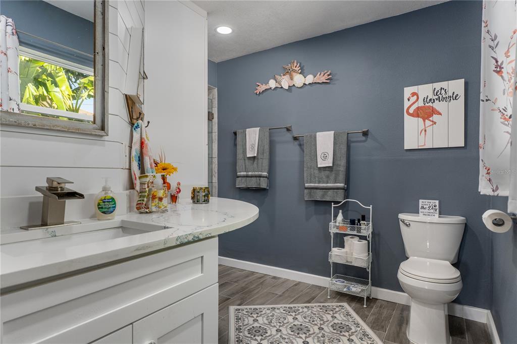 4128 Camelia Drive Hernando Beach, FL 34607 - Photo 23 of 50 a bathroom with a sink a toilet and a mirror