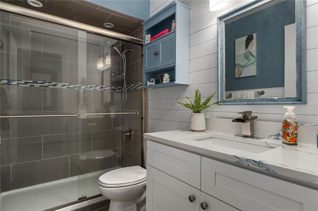 4128 Camelia Drive Hernando Beach, FL 34607 - Photo 26 of 50 a bathroom with a granite countertop sink a toilet and shower