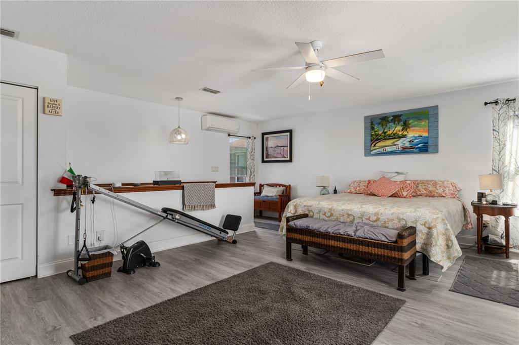 4128 Camelia Drive Hernando Beach, FL 34607 - Photo 28 of 50 a spacious bedroom with a bed and a wooden floor