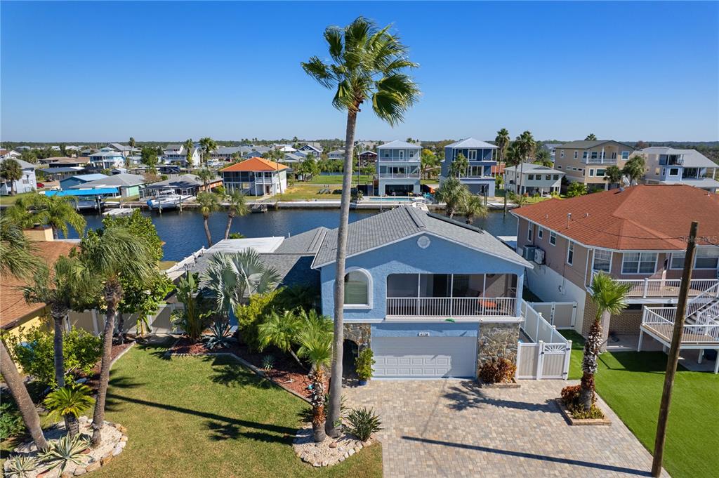4128 Camelia Drive Hernando Beach, FL 34607 - Photo 5 of 50 a front view of a house with a garden