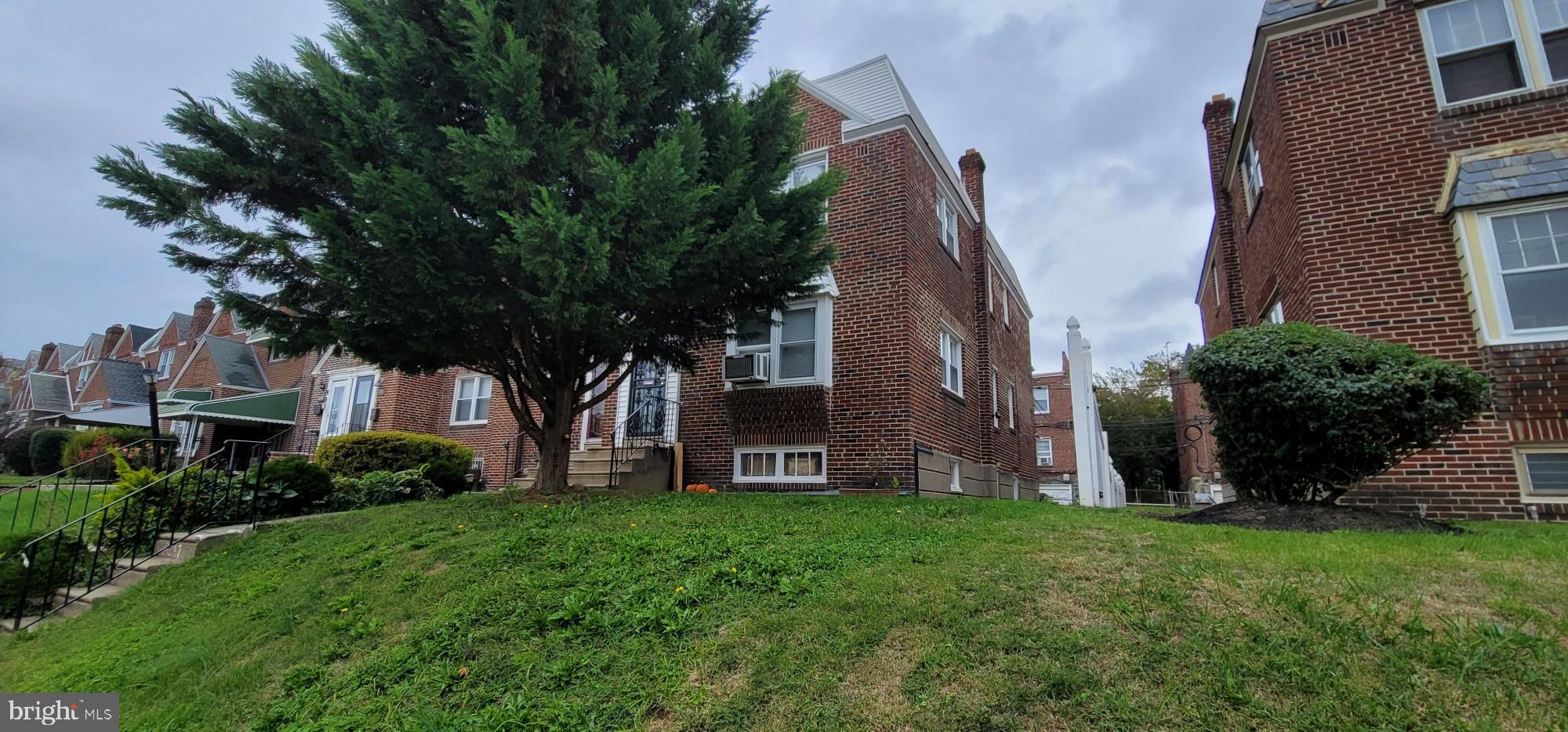 8247 Fayette Street Philadelphia, PA 19150 - Photo 2 of 12 Charming brick home with lush greenery.
