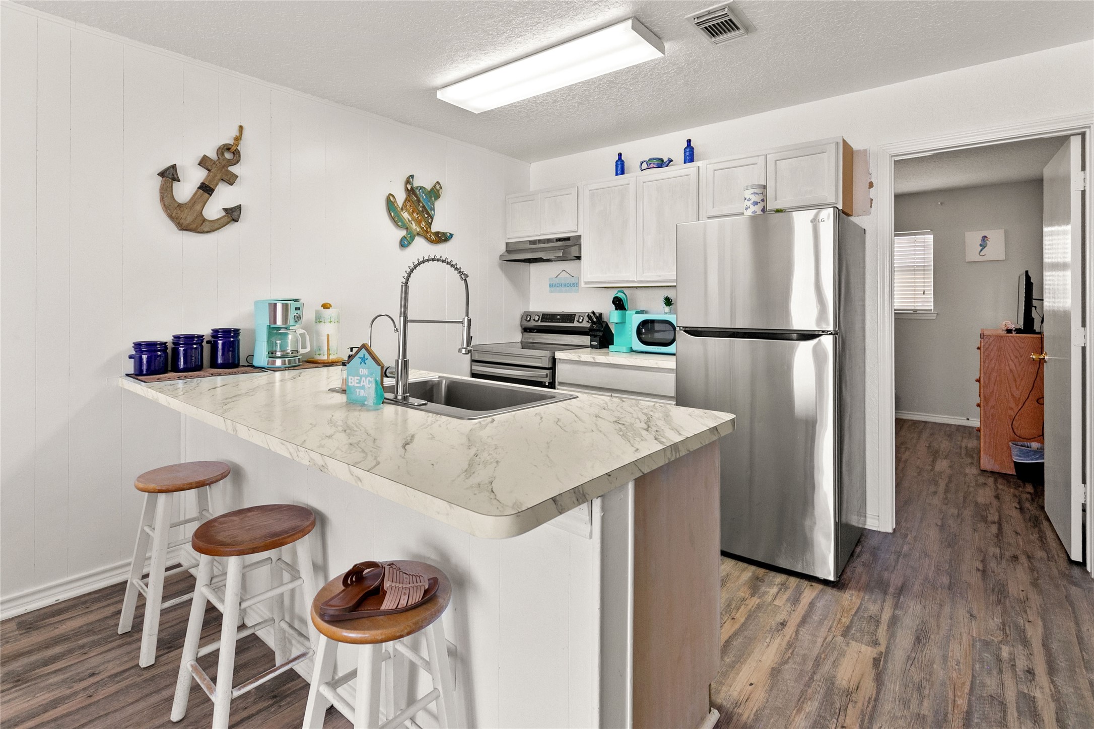 314 Beach Drive Surfside Beach, TX 77541 - Photo 13 of 38 a kitchen with refrigerator and cabinets