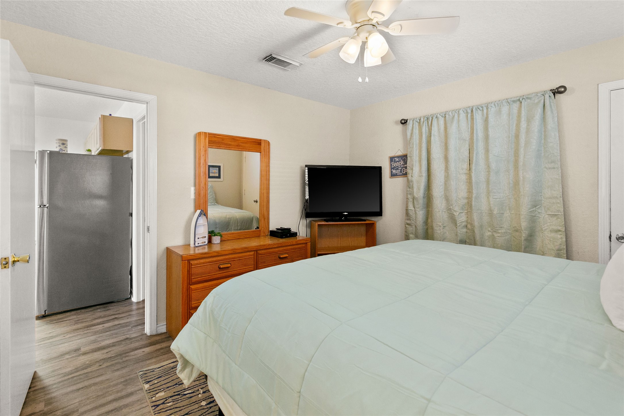 314 Beach Drive Surfside Beach, TX 77541 - Photo 16 of 38 a bedroom with a bed and a flat screen tv