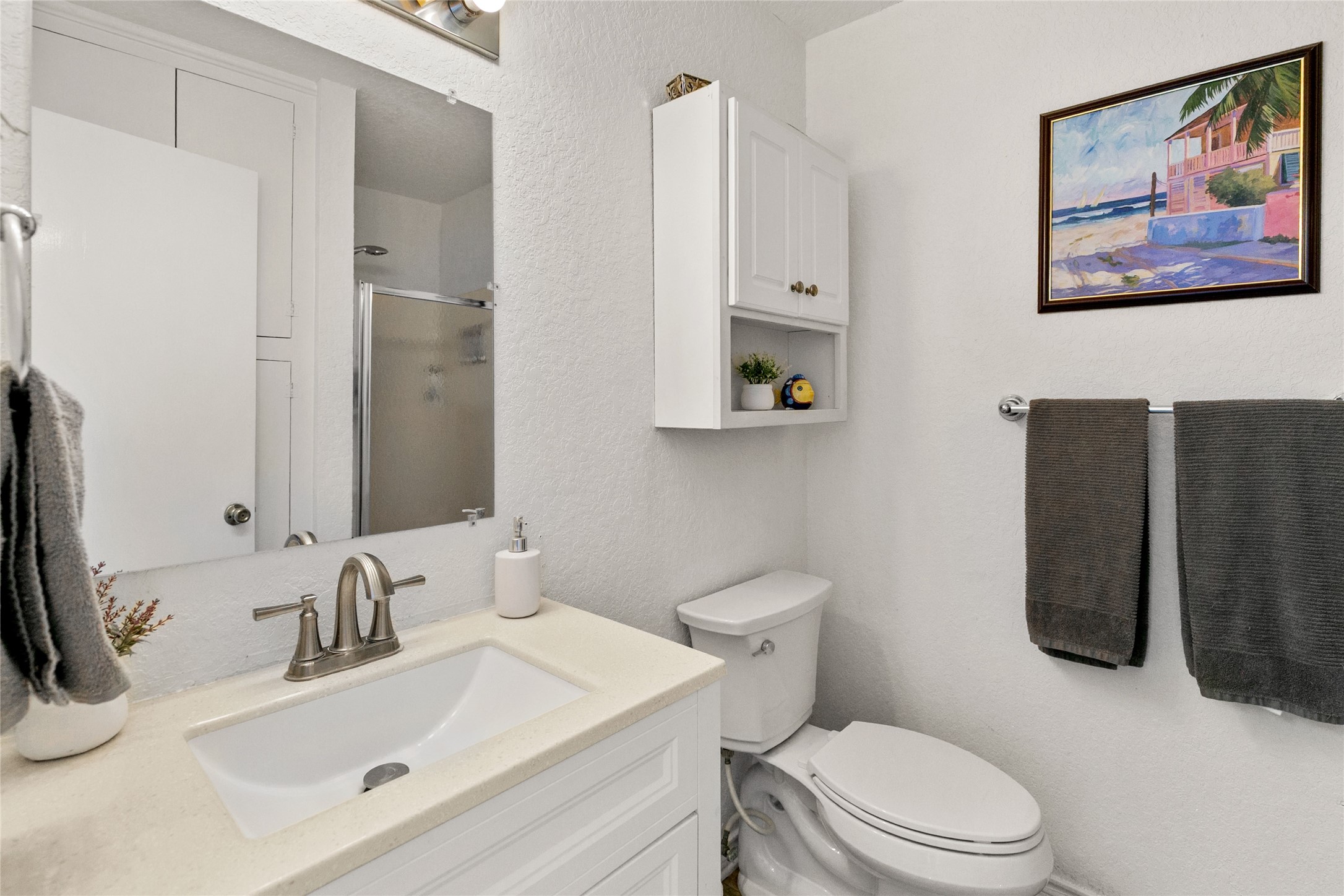 314 Beach Drive Surfside Beach, TX 77541 - Photo 19 of 38 a bathroom with a sink vanity mirror and toilet
