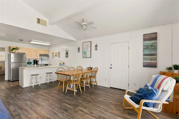 a living room with furniture a flat screen tv and a large window