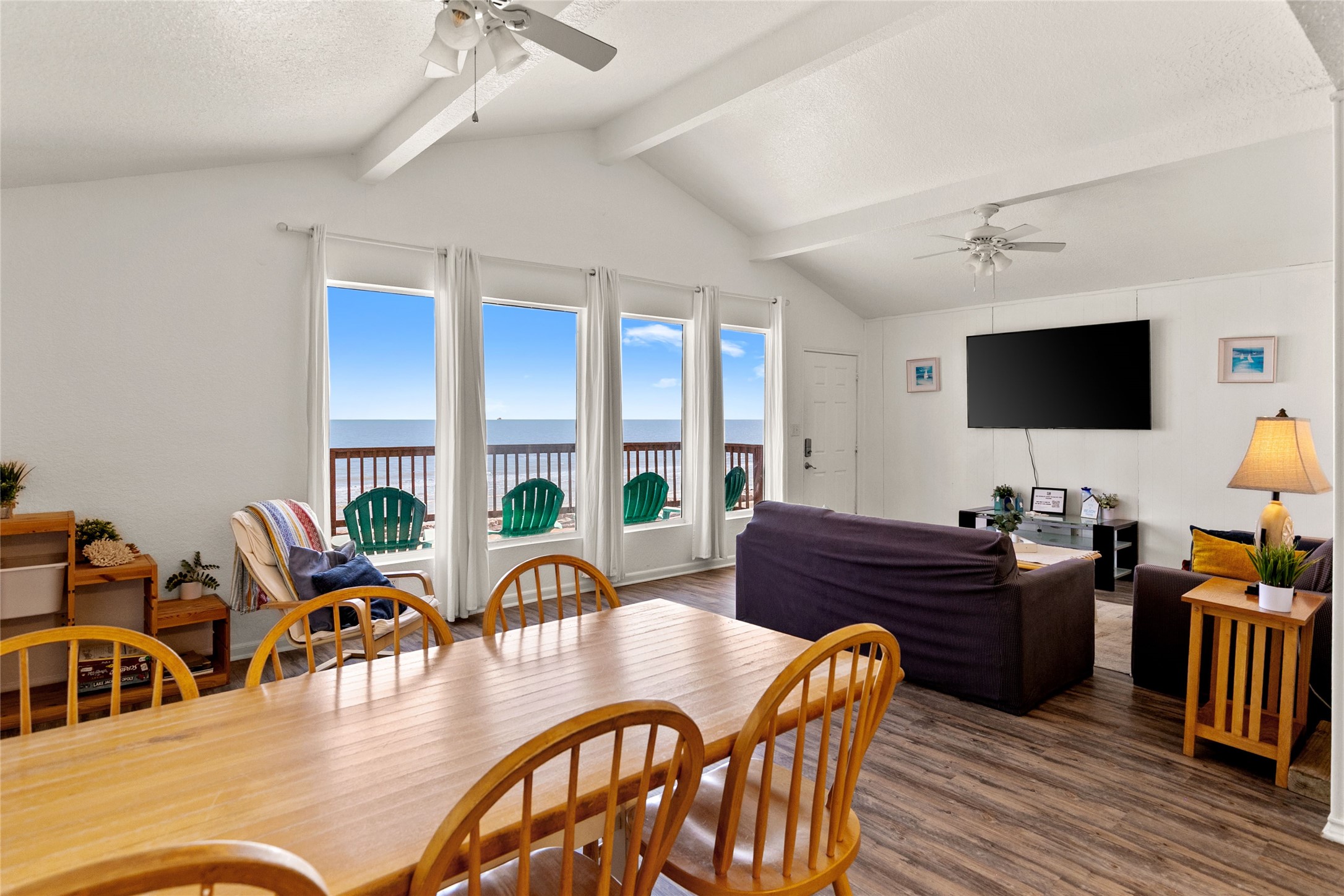 314 Beach Drive Surfside Beach, TX 77541 - Photo 26 of 38 a living room with furniture a flat screen tv and a large window