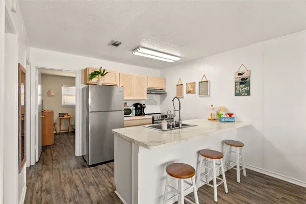 a large kitchen with stainless steel appliances kitchen island granite countertop a sink and cabinets