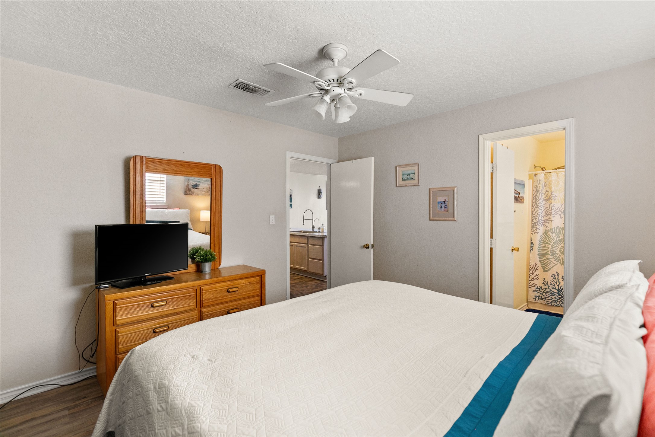 314 Beach Drive Surfside Beach, TX 77541 - Photo 30 of 38 a bedroom with a bed and a flat screen tv