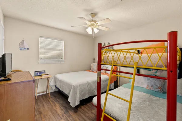 a bedroom with a bed and wooden floor