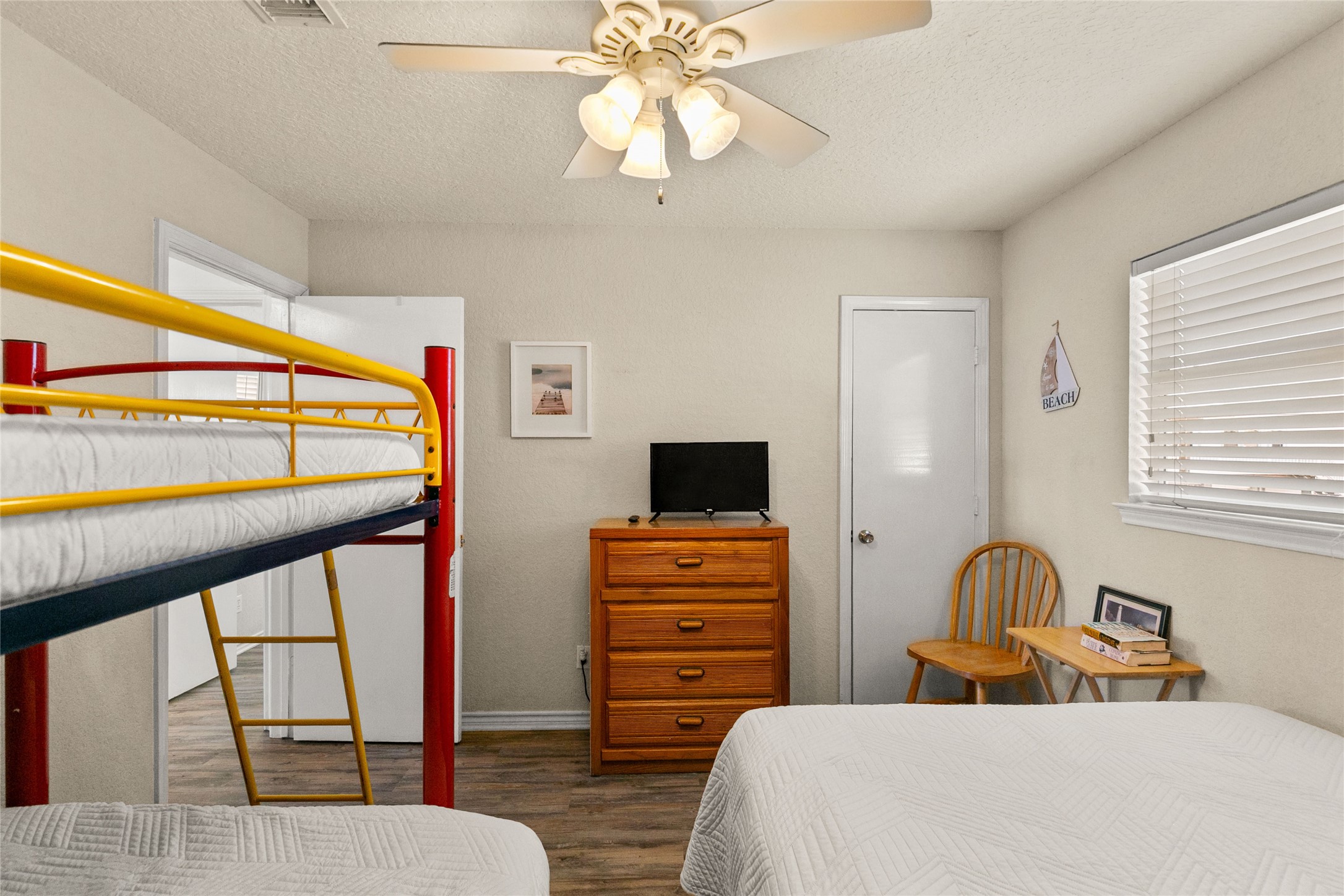 314 Beach Drive Surfside Beach, TX 77541 - Photo 33 of 38 a bedroom with a bed and wooden floor