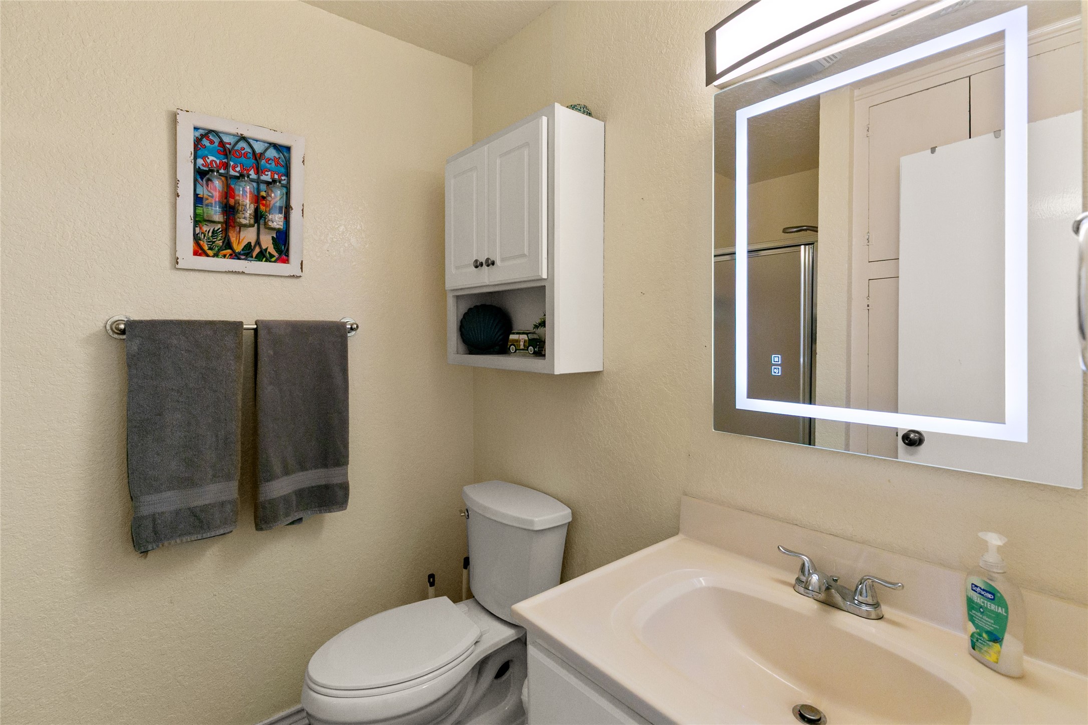 314 Beach Drive Surfside Beach, TX 77541 - Photo 34 of 38 a bathroom with a sink mirror and toilet