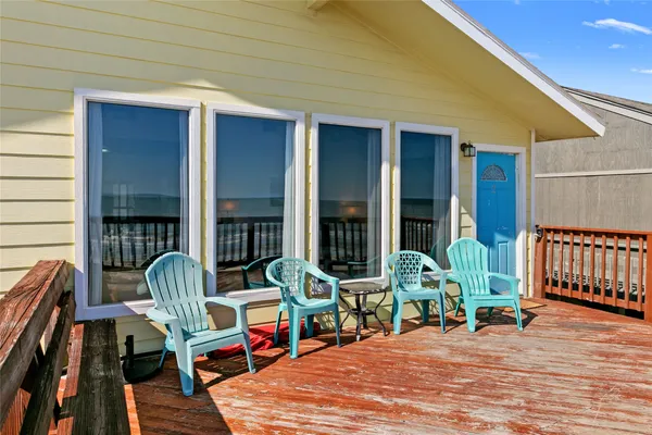 a chair and table in front of a house