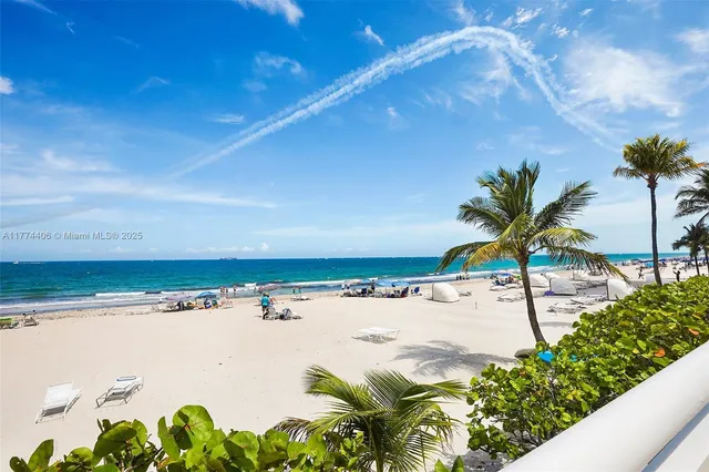 a kitchen with stainless steel appliances granite countertop a sink and a refrigerator