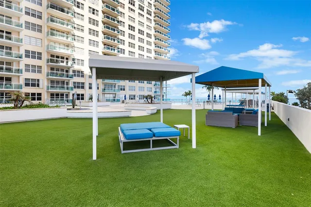 a kitchen with lots of counter space a sink and living room view