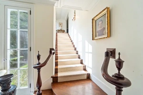 a view of entryway with wooden floor and windows