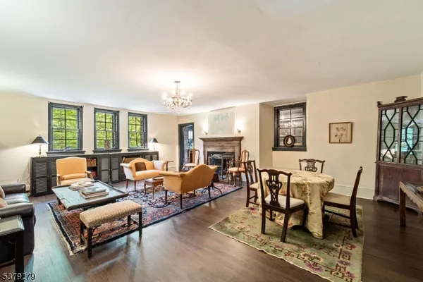 a living room with fireplace furniture and a wooden floor
