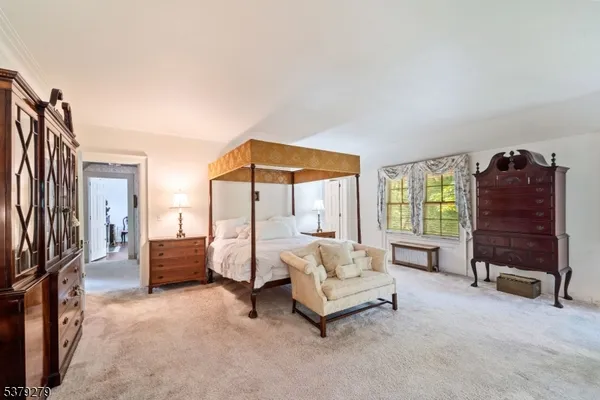 a bedroom with furniture and a window