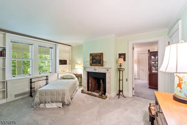 a spacious bedroom with a bed and a fireplace