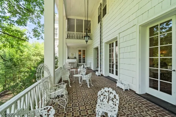 a view of a patio with table and chairs and wooden floor
