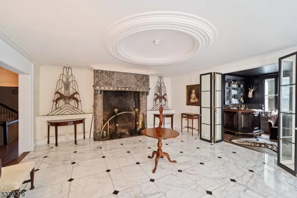 a living room with furniture a fireplace and gym equipment