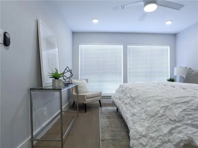 a bedroom with a bed and a potted plant