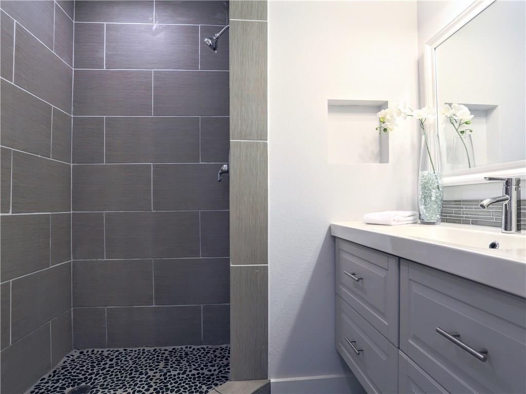 909 Reinli Street, Unit 217 Austin, TX 78751 - Photo 13 of 22 a bathroom with a sink and a mirror