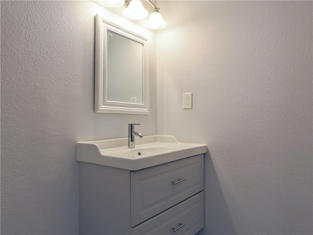 909 Reinli Street, Unit 217 Austin, TX 78751 - Photo 16 of 22 a bathroom with a sink vanity and mirror