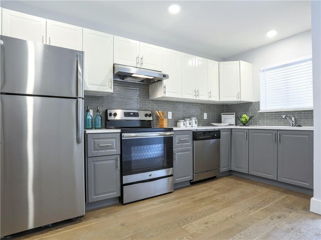 909 Reinli Street, Unit 217 Austin, TX 78751 - Photo 6 of 22 a kitchen with stainless steel appliances a refrigerator sink and cabinets