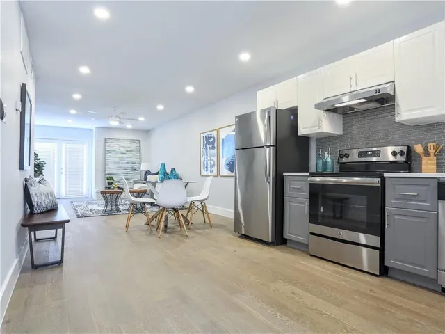 a living room with furniture a fireplace and kitchen view