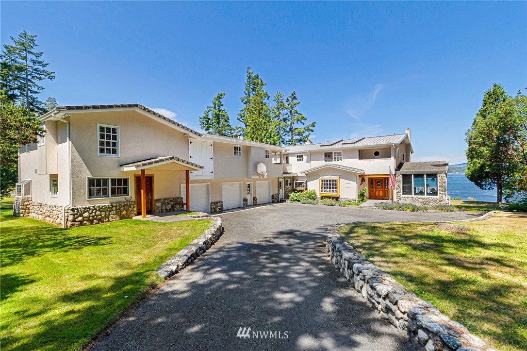 2461 Turn Point Road Friday Harbor, WA 98250 - Photo 2 of 25 a front view of a house with a yard and garage