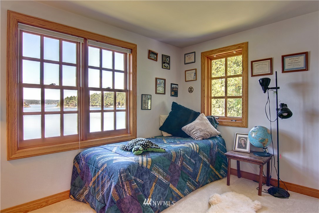 2461 Turn Point Road Friday Harbor, WA 98250 - Photo 11 of 25 a bedroom with a bed and a window