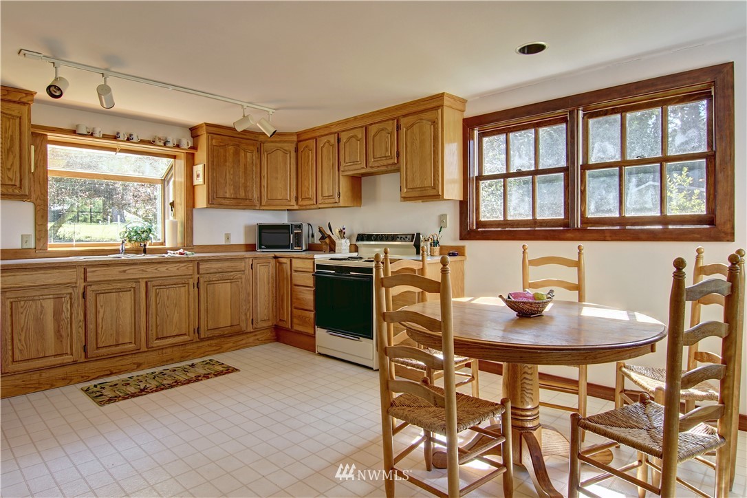 2461 Turn Point Road Friday Harbor, WA 98250 - Photo 15 of 25 a kitchen with a table chairs stove and cabinets