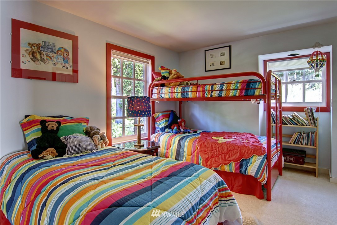 2461 Turn Point Road Friday Harbor, WA 98250 - Photo 17 of 25 a bedroom with two beds and a book shelf