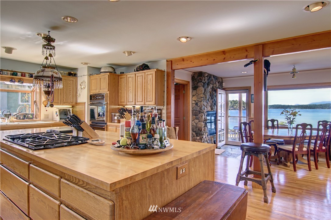 2461 Turn Point Road Friday Harbor, WA 98250 - Photo 6 of 25 a kitchen with stainless steel appliances granite countertop a stove and white cabinets