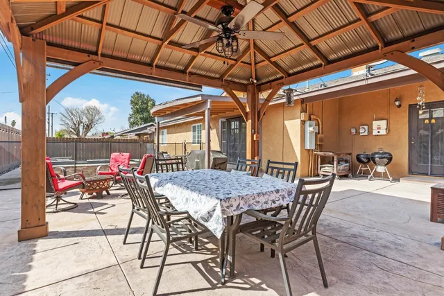 a view of a dining room with furniture and chandelier