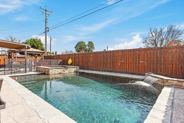 a view of a backyard with sitting area